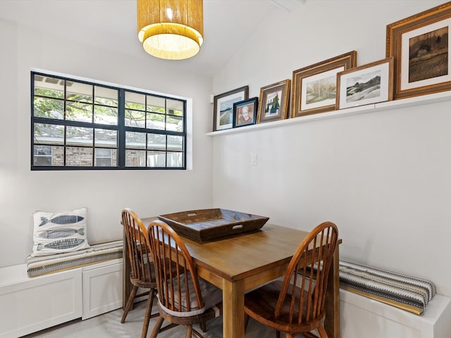 dining space with vaulted ceiling