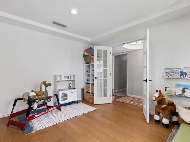 interior space with hardwood / wood-style flooring and french doors