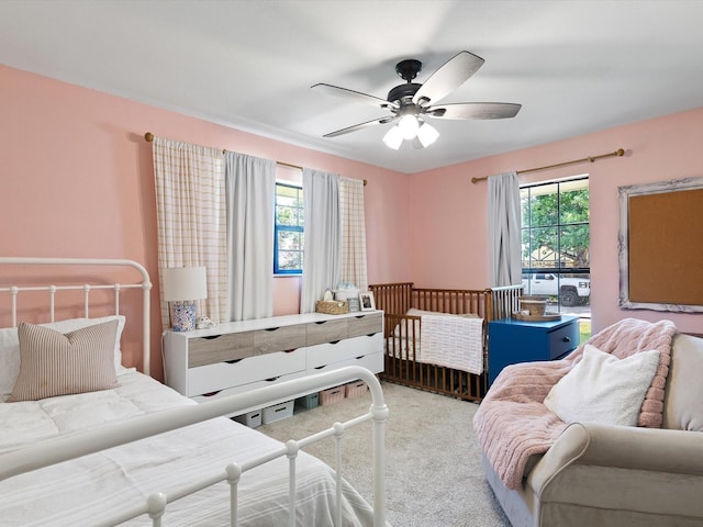 bedroom with ceiling fan and light colored carpet