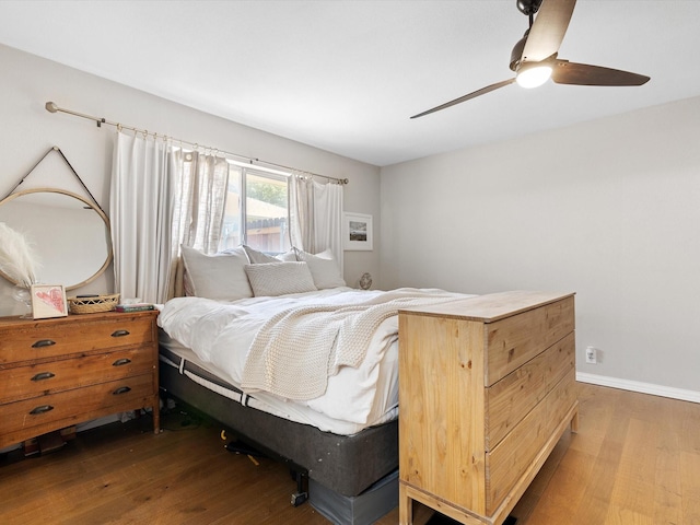 bedroom with dark wood-type flooring and ceiling fan