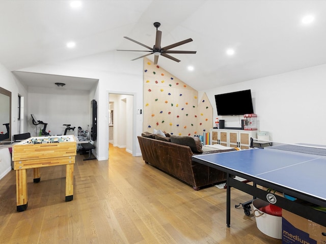 recreation room featuring high vaulted ceiling, ceiling fan, and light hardwood / wood-style flooring