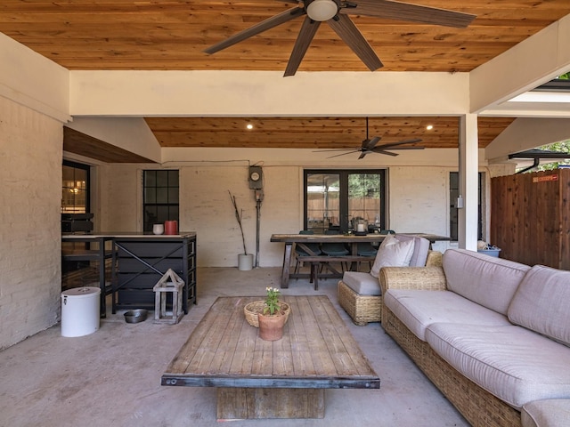 living room with ceiling fan, concrete floors, and wood ceiling