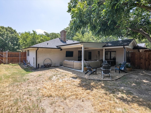 rear view of house with a patio, an outdoor hangout area, a yard, and ceiling fan