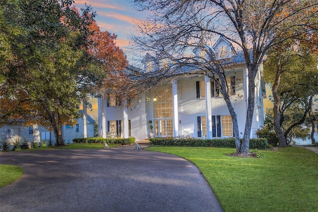 greek revival inspired property with a lawn