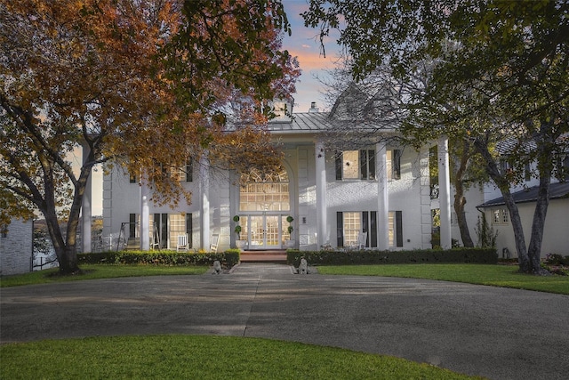 neoclassical home featuring french doors