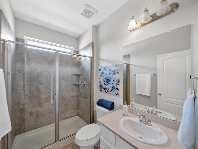 bathroom featuring toilet, vanity, and walk in shower