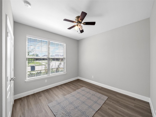 spare room featuring hardwood / wood-style flooring and ceiling fan