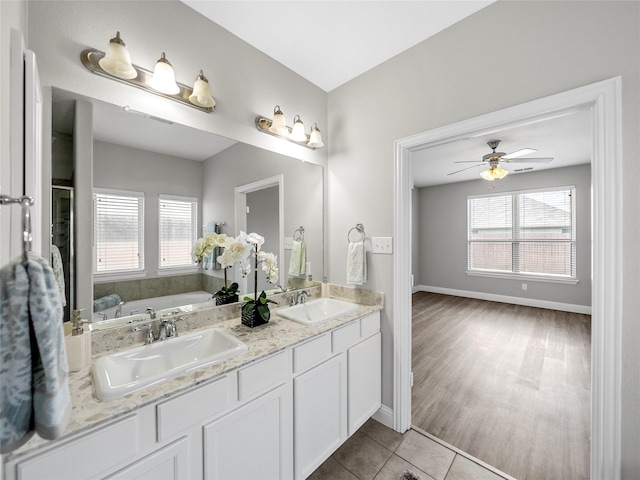 bathroom with a bath, plenty of natural light, tile patterned floors, and ceiling fan