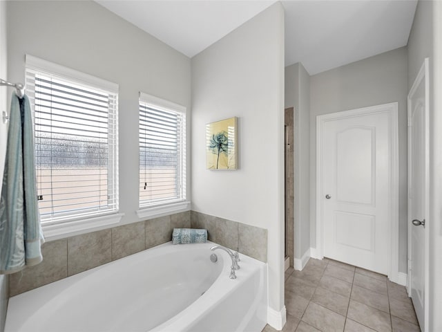 bathroom with separate shower and tub and tile patterned floors