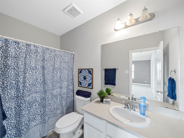 bathroom featuring vanity and toilet