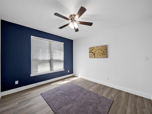 empty room with ceiling fan and wood-type flooring