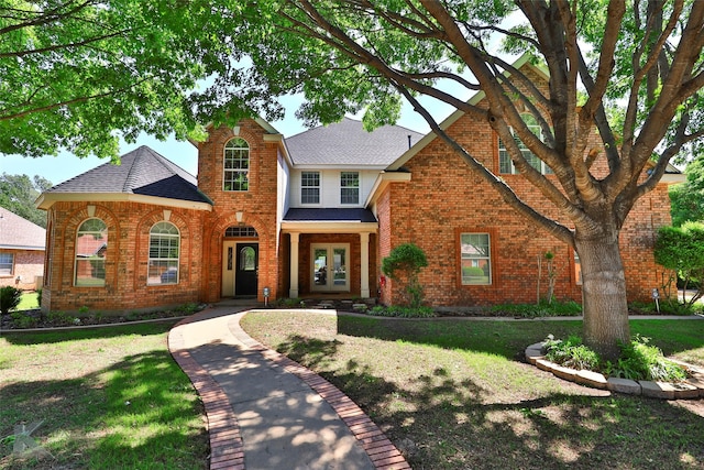 view of front of property with a front lawn and french doors