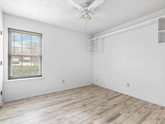 spare room featuring ceiling fan, a textured ceiling, and light wood-type flooring