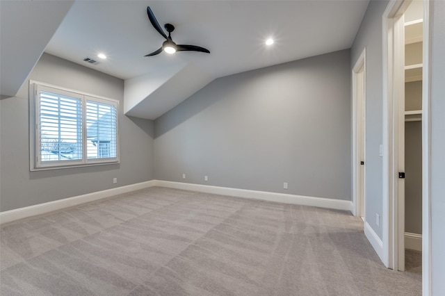 bonus room with ceiling fan, light colored carpet, and vaulted ceiling