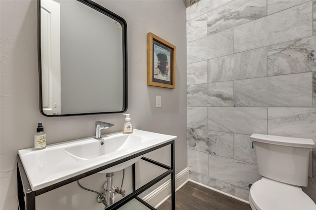 bathroom with wood-type flooring and toilet