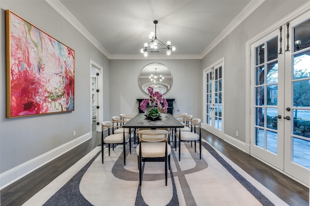 dining space featuring french doors, crown molding, an inviting chandelier, and hardwood / wood-style floors