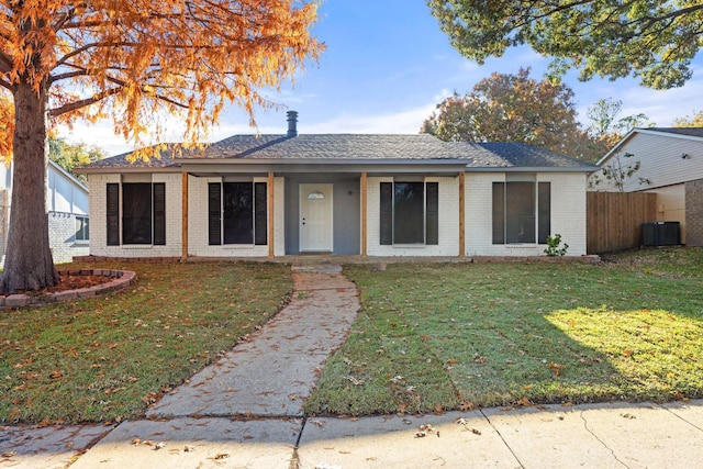 view of front facade with a front yard and central AC unit