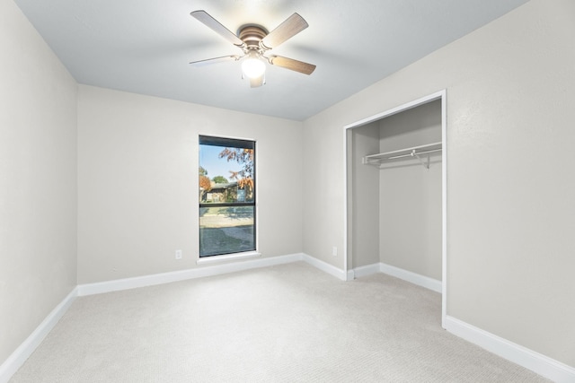 unfurnished bedroom with ceiling fan, a closet, and light carpet