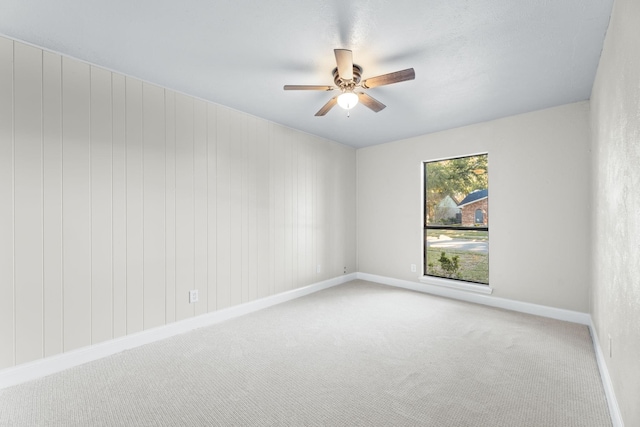 carpeted empty room with ceiling fan