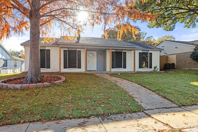 ranch-style home with a front yard and cooling unit