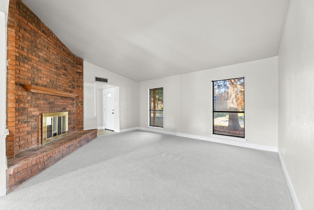 unfurnished living room with lofted ceiling, carpet floors, and a fireplace