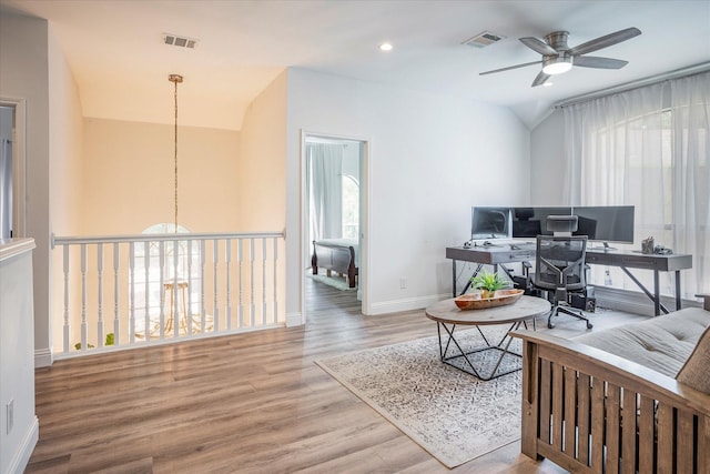 office featuring ceiling fan, wood-type flooring, and a wealth of natural light