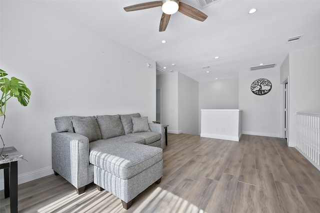 living room with ceiling fan and light wood-type flooring