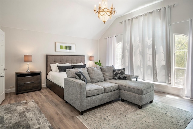 bedroom with wood-type flooring, a chandelier, and vaulted ceiling