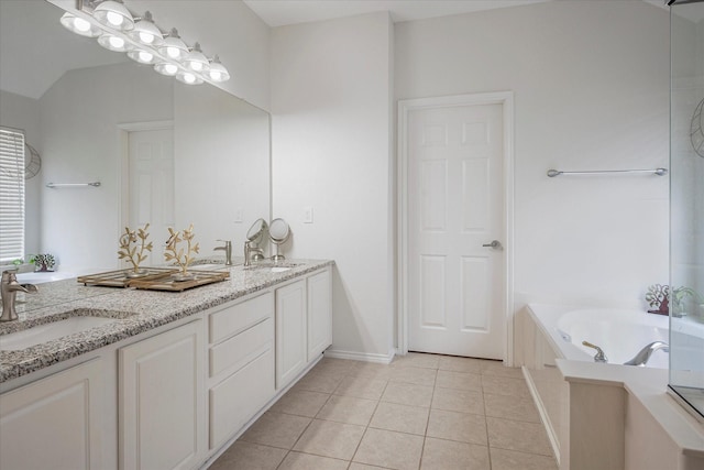 bathroom featuring vanity, a bathing tub, and tile patterned floors