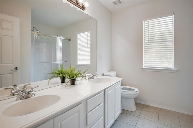 bathroom featuring tile patterned flooring, walk in shower, a healthy amount of sunlight, and toilet