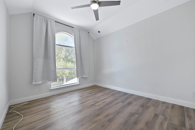 spare room with wood-type flooring, lofted ceiling, and ceiling fan