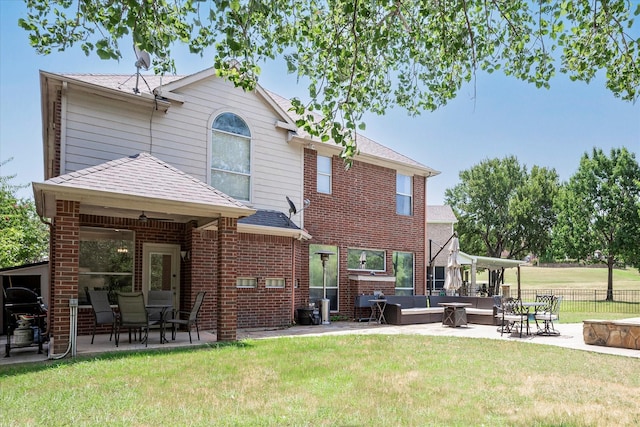 rear view of property featuring an outdoor hangout area, a yard, ceiling fan, and a patio area