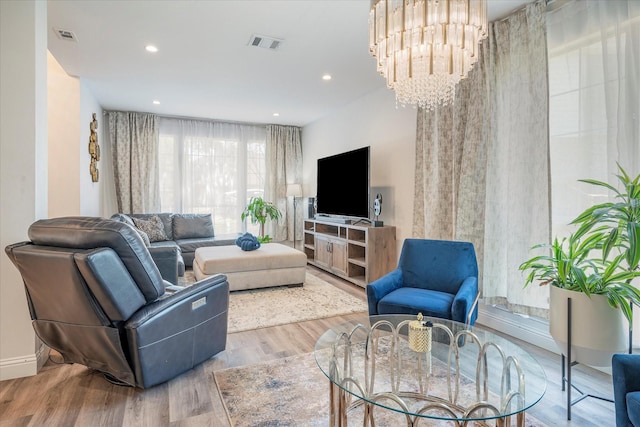 living room featuring a chandelier and light hardwood / wood-style floors