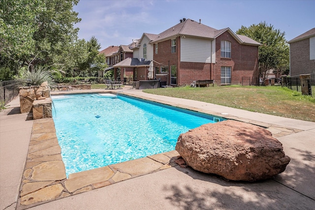 view of pool featuring a lawn