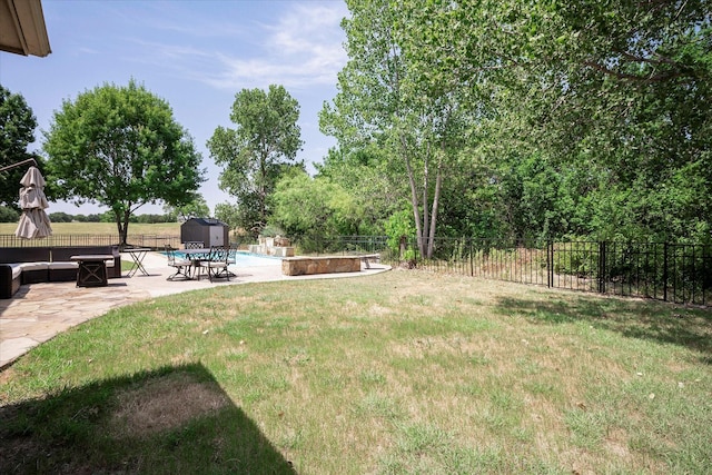 view of yard with a patio and a shed