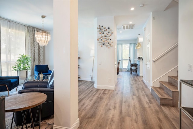 corridor with light hardwood / wood-style floors