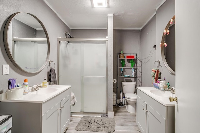 bathroom featuring vanity, hardwood / wood-style floors, ornamental molding, and an enclosed shower