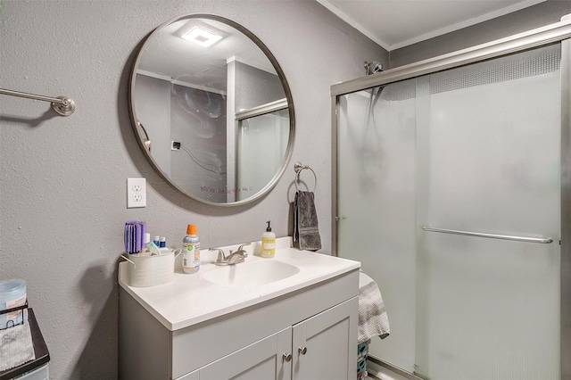 bathroom featuring a shower with door, vanity, and crown molding