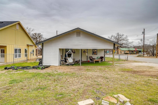 back of property featuring a lawn