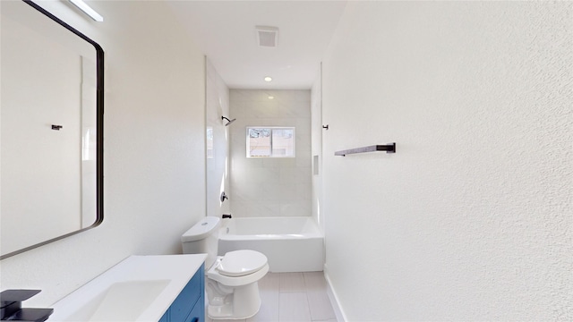 full bathroom featuring tile patterned flooring, vanity, tiled shower / bath, and toilet