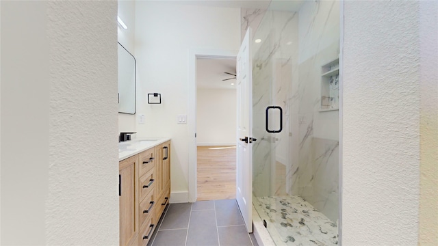 bathroom with vanity, a shower with shower door, and tile patterned flooring