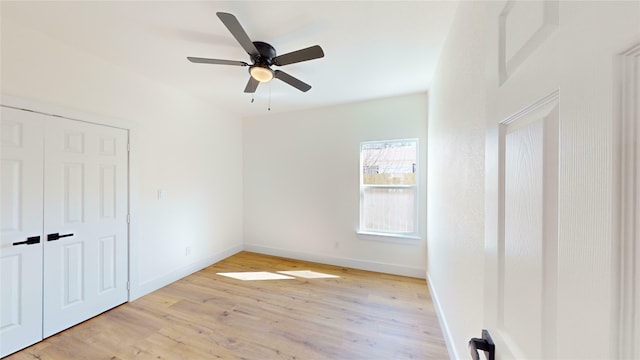 unfurnished bedroom with ceiling fan and light hardwood / wood-style flooring