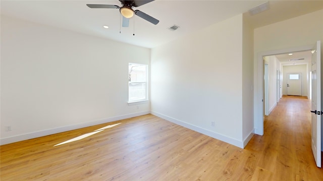 empty room featuring ceiling fan and light wood-type flooring