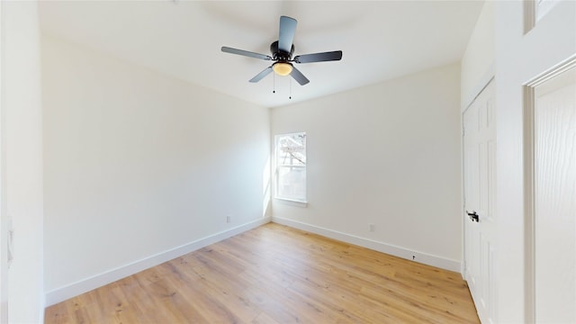 spare room with ceiling fan and light wood-type flooring