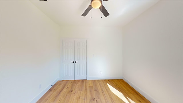 empty room featuring ceiling fan and light hardwood / wood-style flooring