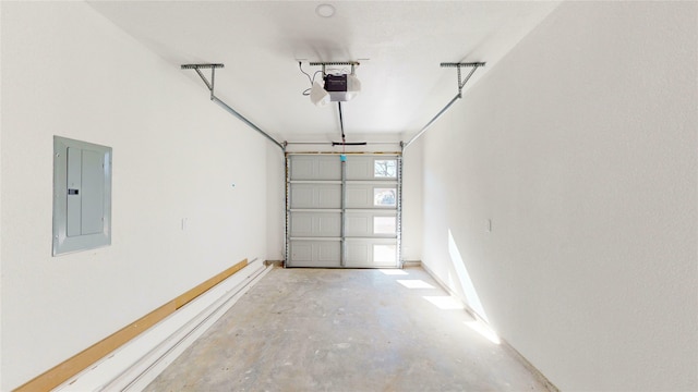 garage with a garage door opener and electric panel