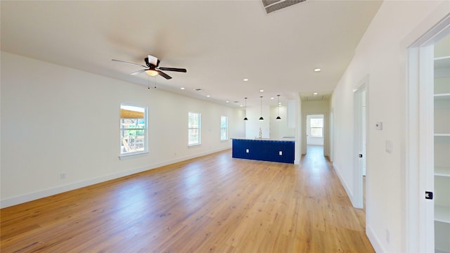 unfurnished living room with ceiling fan and light hardwood / wood-style floors