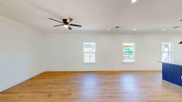 empty room featuring ceiling fan and light hardwood / wood-style floors