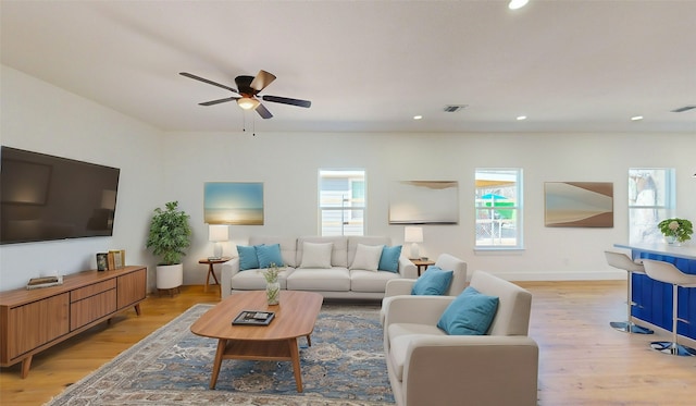 living room with ceiling fan and light wood-type flooring