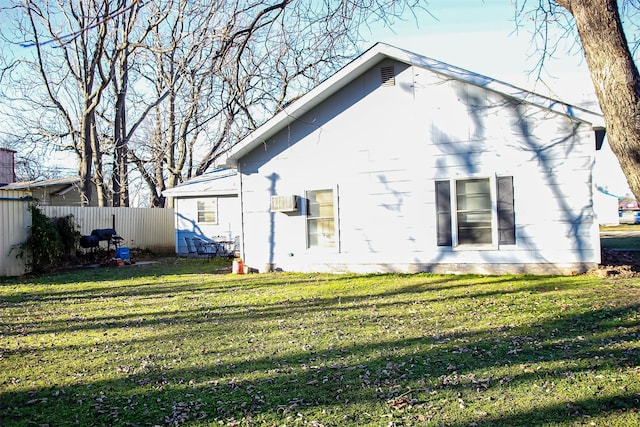 back of property with a lawn